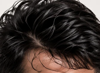 Close-up of thick, dark men's hair